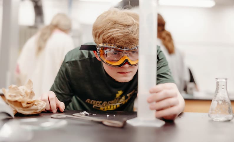 Student in the lab wearing safety goggles